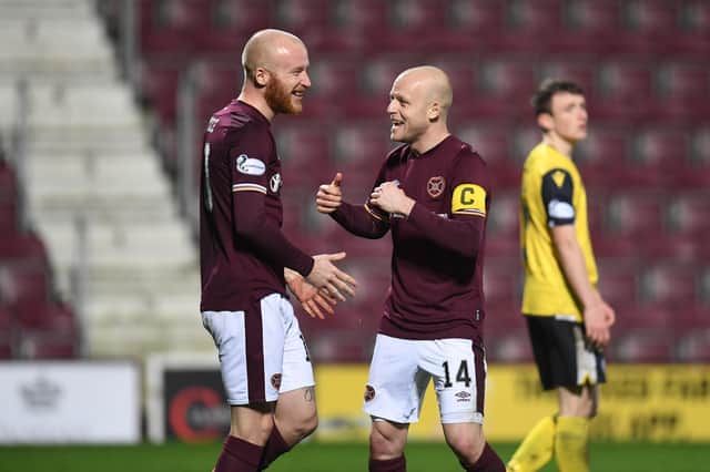 Liam Boyce celebrates with Steven Naismith after putting Hearts 3-0 up against Queen of the South. Picture: SNS