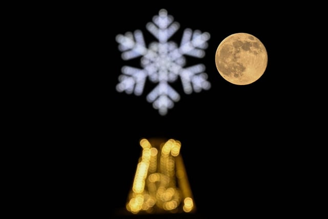 The Wolf moon behind a Christmas and New Year's decoration in Moscow on January 7, 2023.
