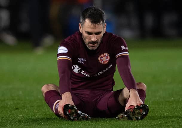 A dejected Michael Smith sits on the turf at full-time. Picture: SNS