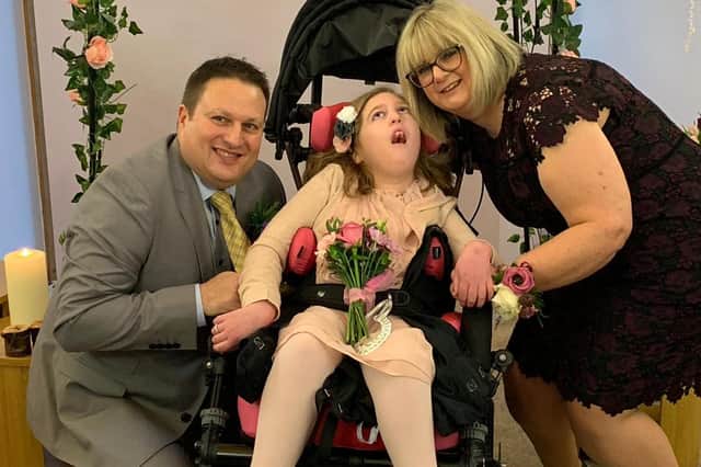 Ava and her parents, Fiona and Keith Young, at a special vow renewal they organised for their 20th anniversary at Rachel House in Kinross where Ava receives respite care.