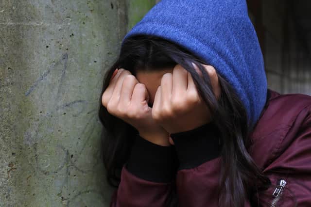 A teenage girl with her head in her hands showing signs of mental health issues. (posed by model)
Pic: Gareth Fuller/PA