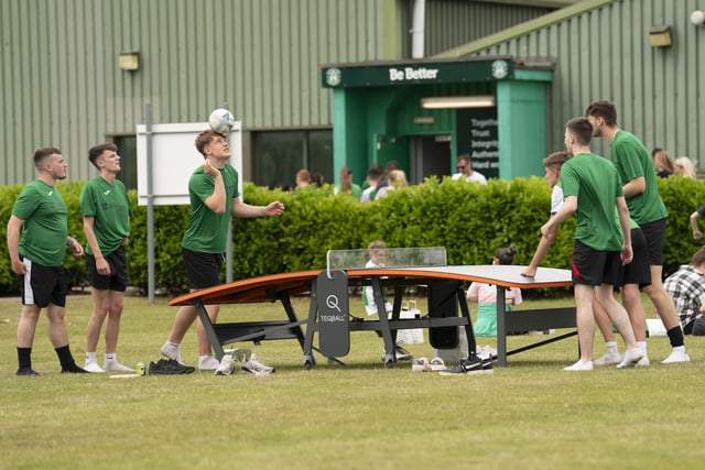 These 24-hour football marathon participants warm up with a little bit of football table tennis at the Hibs training ground.