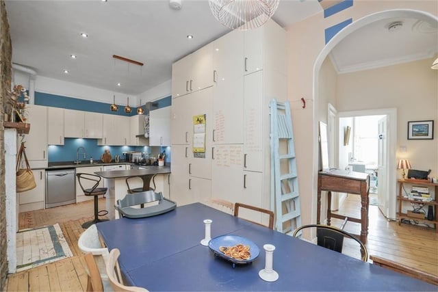 The property has a contemporary dining kitchen with stunning exposed stone wall and generous dining space.