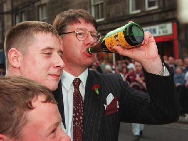 Edinburgh Lord Provost Eric Milligan enjoys a wee sip of Buckfast wine with Hearts fans after their team beat Rangers 2-1 to win the Scottish Cup 1998.