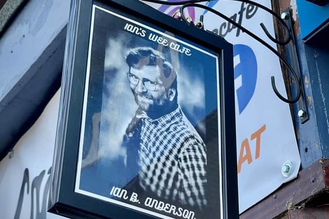 Photo of Ian on the cafe signage