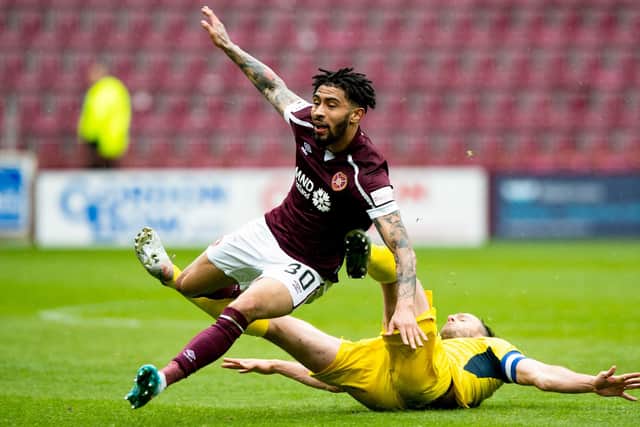 Ross County's Keith Watson wipes out Josh Ginnelly at Tynecastle.