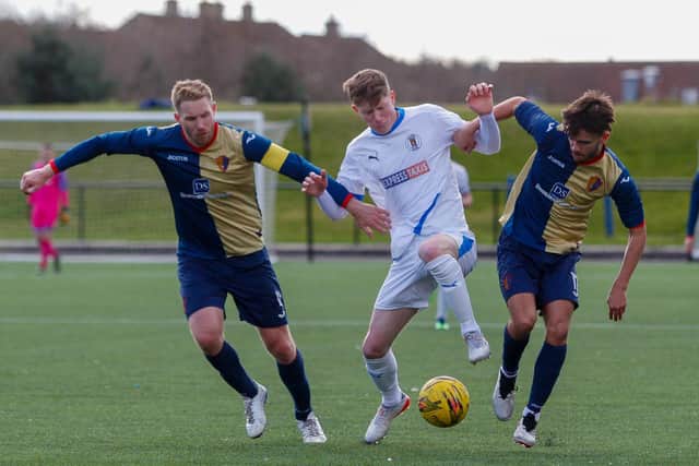 Kyle Wilson looks to hold onto the ball with two East Kilbride players in close attention. Pictures: Scott Louden