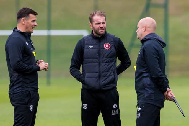 Hearts coaching staff Lee McCulloch and Gordon Forrest flank manager Robbie Neilson at Riccarton training.