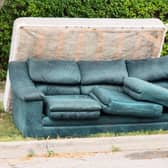 Stock photo of a mattress and couch placed outside by the curb on garbage day in Midlothian.