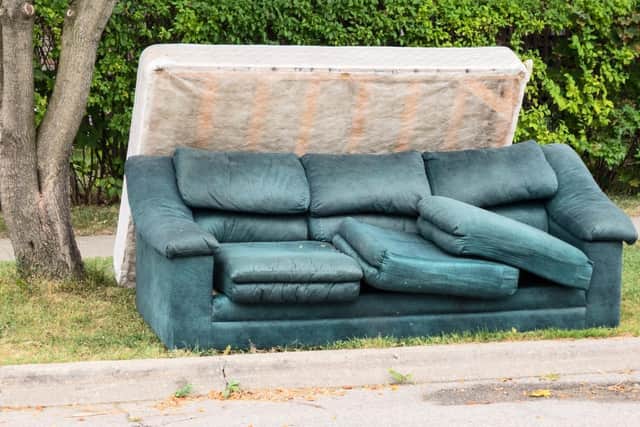 Stock photo of a mattress and couch placed outside by the curb on garbage day in Midlothian.