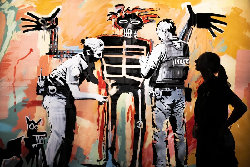 'Basquiat being stop and searched' (London 2017) on display at the new show by street Banksy 'Cut & Run' opens this Sunday at Glasgow's GoMA, revealing for the first time the stencils used to create many of the artist's most iconic works.