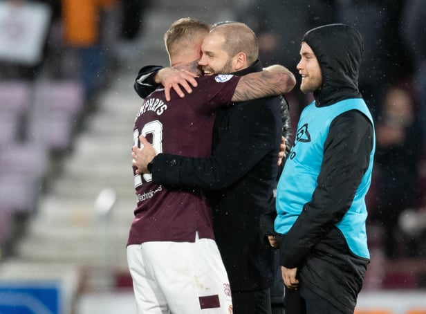 Hearts manager Robbie Neilson hugs Stephen Humphrys at full-time against Dundee United.