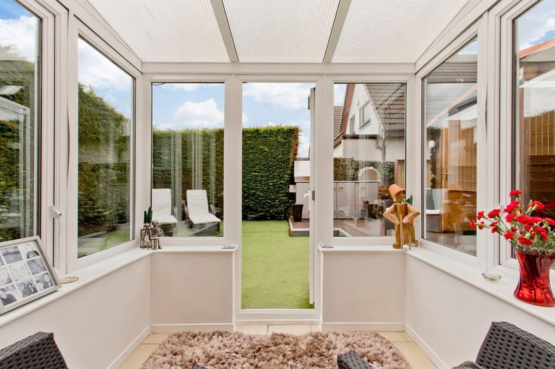 The light and airy southwest-facing conservatory is the perfect spot to sit and relax, looking out into the garden.