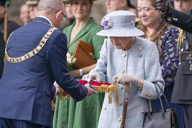 Queen Elizabeth II inspects the keys presented by Lord Provost Robert Aldridge (left) during the Ceremony of the Keys on the forecourt of the Palace of Holyroodhouse in Edinburgh, accompanied by the Earl and Countess of Wessex. Picture: Jane Barlow/PA Wire