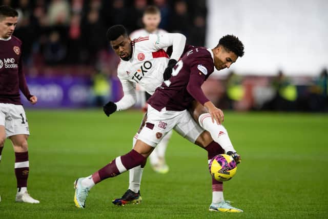 Aberdeen's Luis Lopes is challenged by Hearts defender James Hill. Picture: Mark Scates / SNS