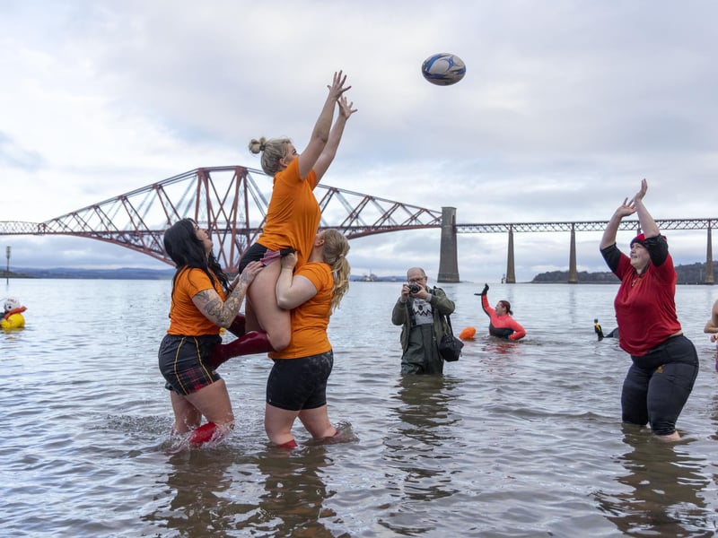 Rugby players enjoy a game in the waters