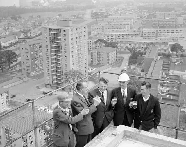 The Muirhouse Flats topping out ceremony (right-left) T. Kelly (ganger), A.McLeod of William Arnott McLeod Ltd, Councillor Pat Rogan, R. Mackie (head foreman) and R.Williams (joiner) in August 1964.