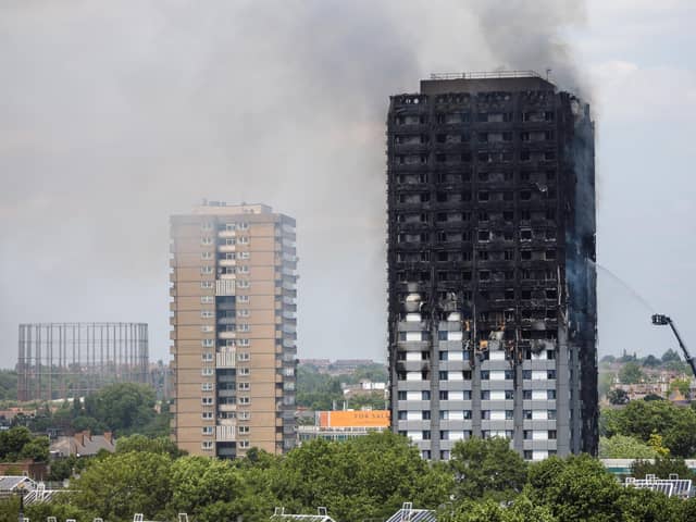 Smoke rises from the building after a huge fire engulfed the 24 storey residential Grenfell Tower block in Latimer Road, West London in the early hours of this morning on June 14, 2017.