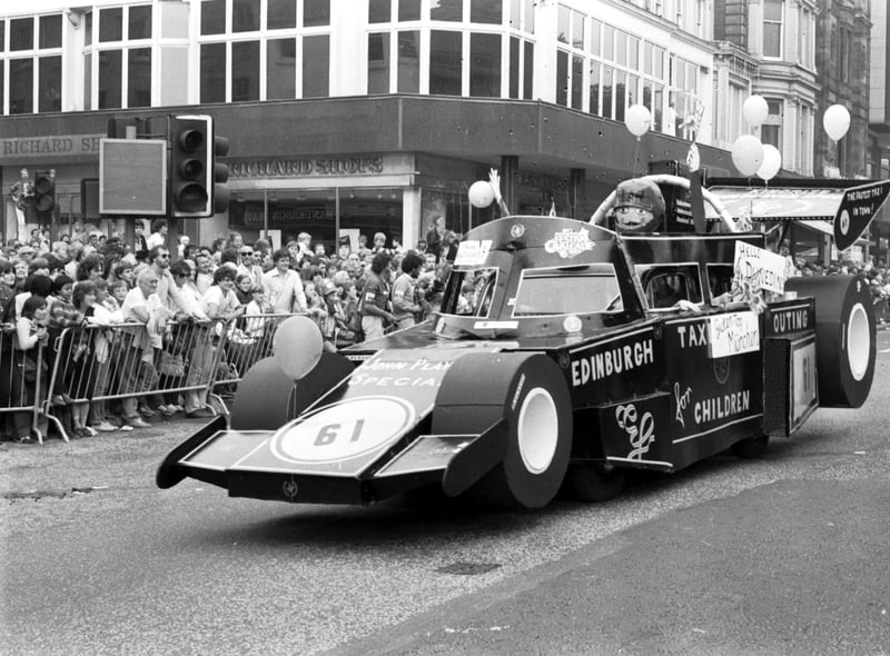 An Edinburgh taxi dressed as a racing car makes its way along Princes Street in the Evening News Festival Cavalcade, August 1983.
