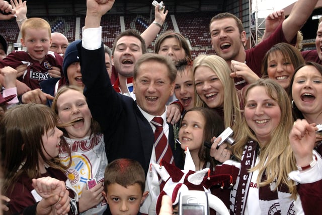Hearts owner Vladimir Romanov celebrates with fans at Tynecastle Park after the side won the Scottish Cup by defeating Gretna on penalties in 2006.