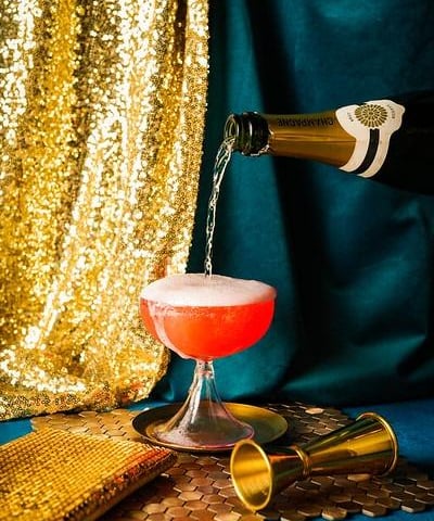 The Classic Champagne Cocktail made with champagne, cognac, verjus, pineau de charente, all poured over a sugar cube saturated with bitters.