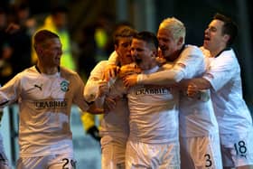 Paul Cairney (centre) is mobbed by his team-mates after scoring for Hibs against St Johnstone