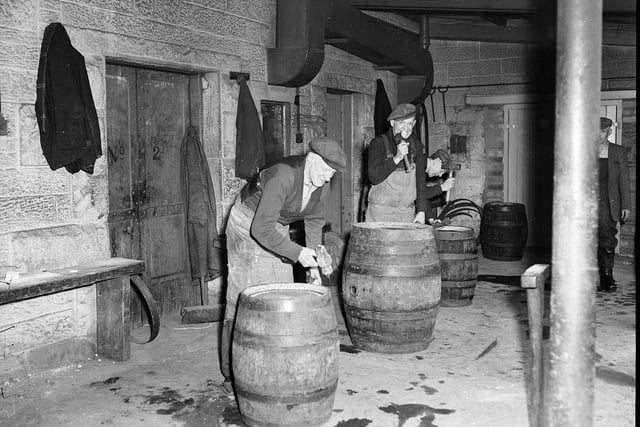 Ushers Brewery  St Leonards Edinburgh - Coopers tighten hasps on barrel of beer.