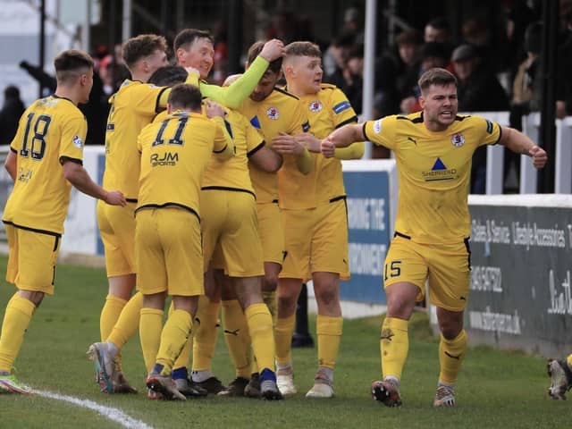 Kerr Young is mobbed by his team-mates after his winner at Elgin. Picture: Joe Gilhooley LRPS.