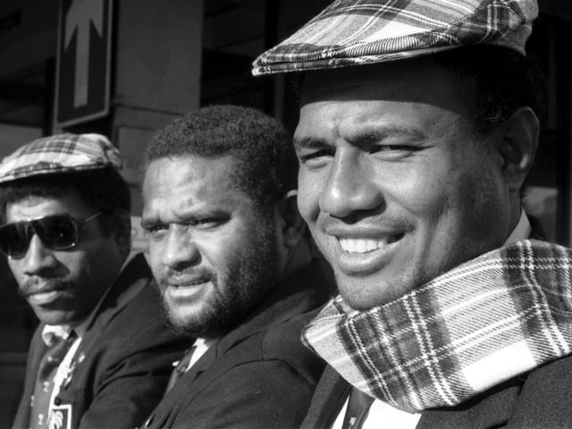 Fijian rugby players Esala Telini, Sala Nanilawsa and Ilisoni Naituku dressed in tartan arrive at Edinburgh Airport ahead of the Scotland v Fiji international rugby match in October 1989.