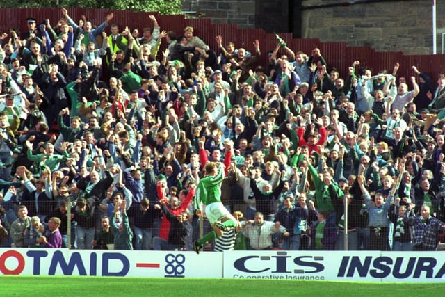 Gordon Hunter, team captain, celebrates scoring with Hibs fans during the Hearts v Hibs Edinburgh derby football match at Tynecastle in August 1994. His was the only goal of the game which saw the Leith side end Hearts' domination in the derby which stretched to a 22-match unbeaten run.