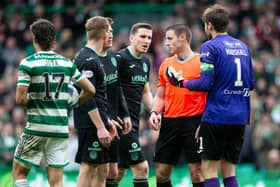 Hibs players surround referee Steven McLean during the defeat to Celtic last time out. Picture: SNS