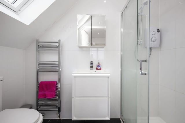 One of the property's two en-suite bathrooms, with this one off the principal bedroom.