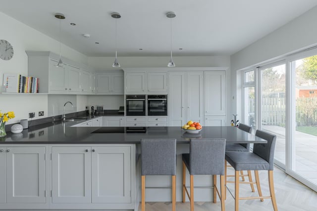 The stylish dining kitchen which has been fitted with an excellent assortment of bespoke contemporary units/co-ordinated worktops and features a range of high spec integrated appliances, beautiful herringbone flooring, breakfast bar/dining area and doors opening directly out to the rear garden.