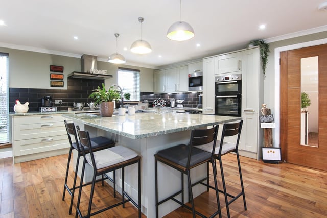 The extensive kitchen includes many high standard features such as a wine fridge and a beautiful marble island. Bi-fold doors open up onto the immaculate garden, allowing natural light to flood in and connect the indoors with the outdoors.