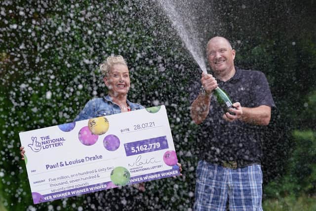 Paul and Louise Drake, from Seafield near Bathgate, spray champagne to celebrate their £5.16 million pound lottery win
