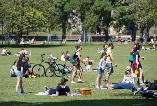 People sunbathe and exercise in the good weather in The Meadows in May last year (Picture: Jane Barlow/PA)