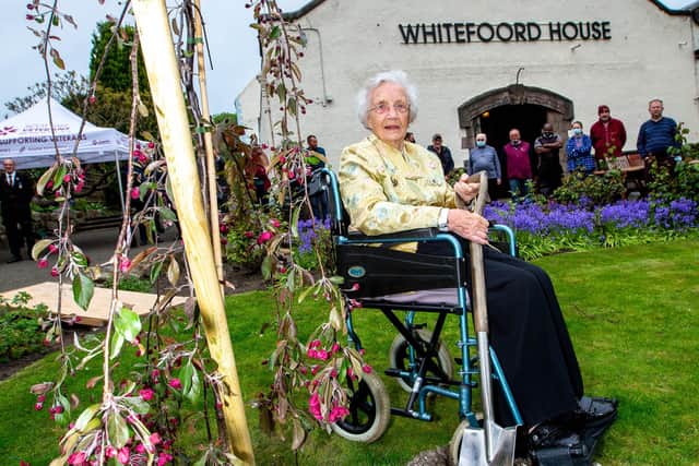 Margaret Runcie, 96, joined residents of Edinburgh’s Whitefoord House as she planted a tree on the grounds during the event on Tuesday. Photo: Murray K Kerr