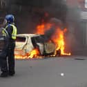 A car burns on Parliament Road, in Middlesbrough, during an anti-immigration riot. Credit: Owen Humphreys/PA Wire