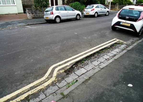 Double yellow parking lines bypass a pothole