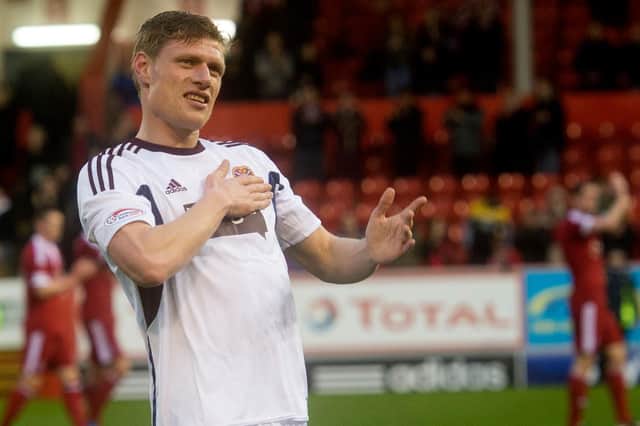 Marius Zaliukas salutes the Hearts fans after making his final appearance for the club at Pittodrie in May 2013. Picture: SNS