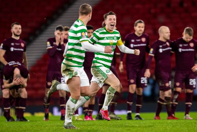 Celtic players celebrate with distraught Hearts in the background.