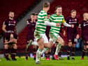 Celtic players celebrate with distraught Hearts in the background.
