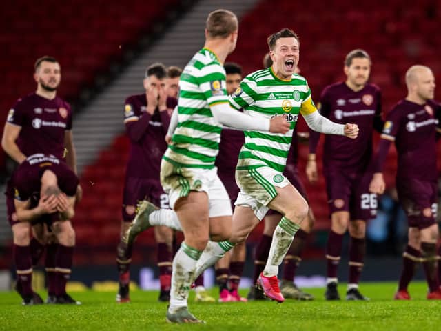 Celtic players celebrate with distraught Hearts in the background.