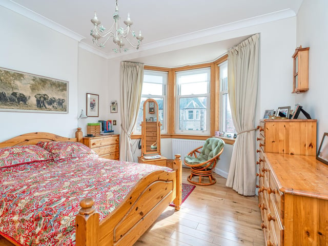 The principal double bedroom with bay window and two built-in wardrobes.