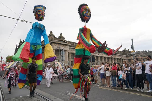 Performers parade along Princes Street in Edinburgh in the Edinburgh Festival Carnival. Performers from more than 13 countries, take part in the event. Picture date: Sunday July 17, 2022.