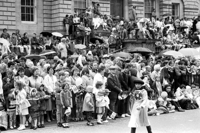 Crowds gathered in the rain outside resister House in Princes Street to watch the Evening news-sponsored Edinburgh Festival Cavalcade in August 1985