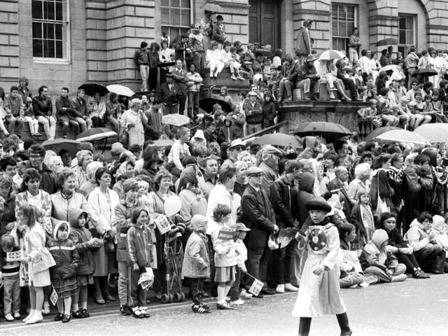 Crowds gathered in the rain outside resister House in Princes Street to watch the Evening news-sponsored Edinburgh Festival Cavalcade in August 1985