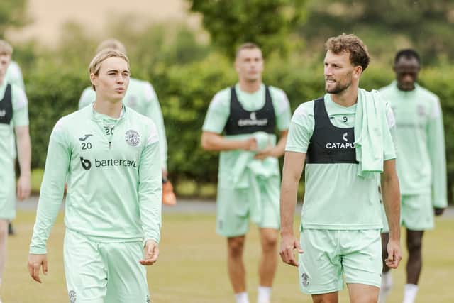 Doidge, right, with Elias Melkersen, is the Easter Road side's most senior No.9