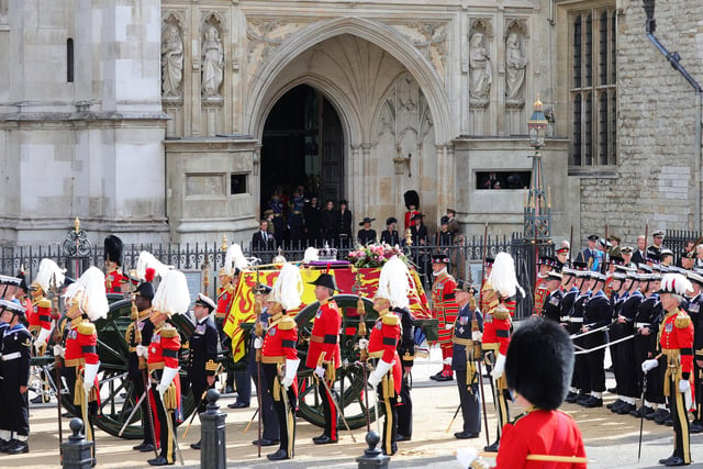 Prince William, Prince of Wales, Prince Richard, Duke of Gloucester, King Charles III, Prince Harry, Duke of Sussex, Vice Admiral Sir Timothy Laurence, Anne, Princess Royal and Prince Andrew, Duke of York watch on as The Queen's funeral cortege borne on the State Gun Carriage of the Royal Navy as it departs Westminster Abbey  (Photo by Chris Jackson/Getty Images)