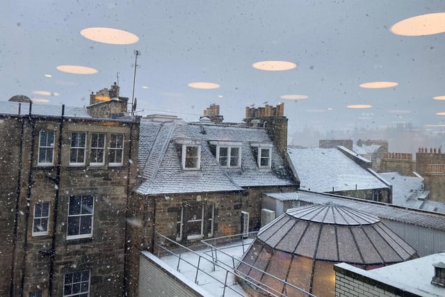 Rooftops looked as though they'd been dusted with icing sugar, as flurries of snowflakes fell on the city.